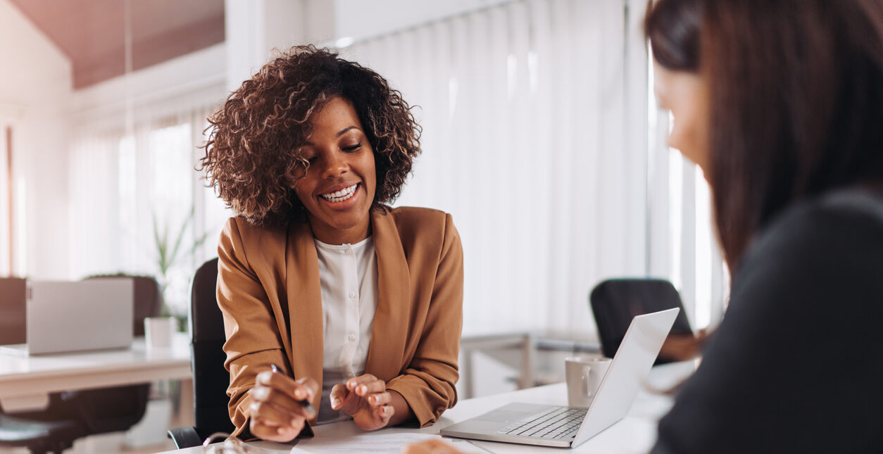 Female client consulting with a agent in the office.